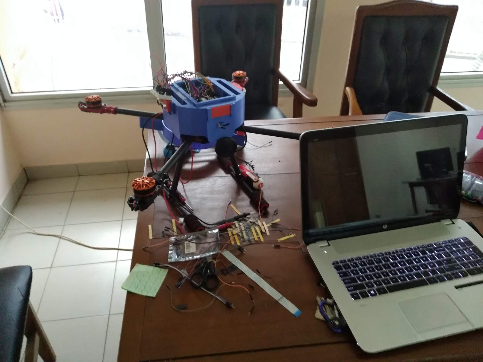 SkyBulb drone next to the laptop during a test